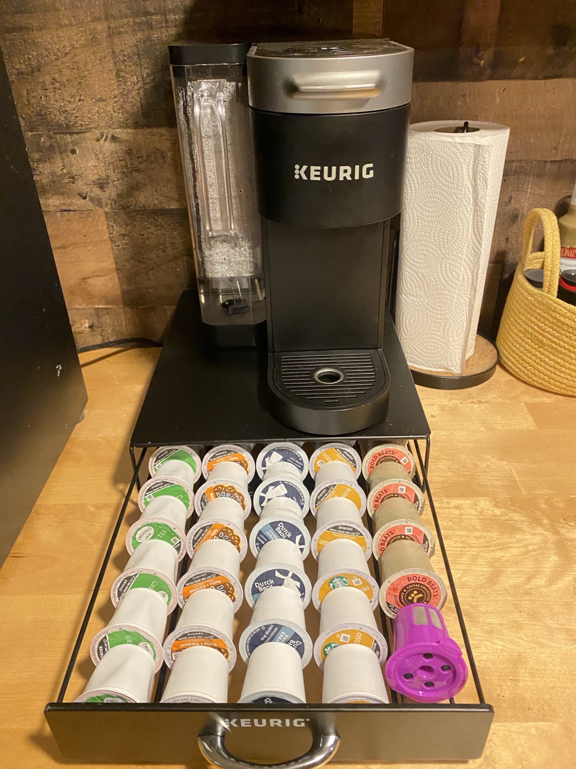 Keurig coffee maker with a stocked selection of coffee and tea pods